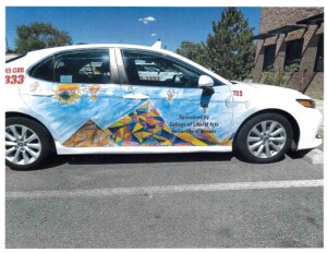 Featured image showing a taxi cab wrapped with local student artwork